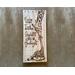 Giraffe nursery wall decor. A giraffe mother kisses a baby giraffe's head. The artwork is drawn using pyrography tools onto reclaimed wood.